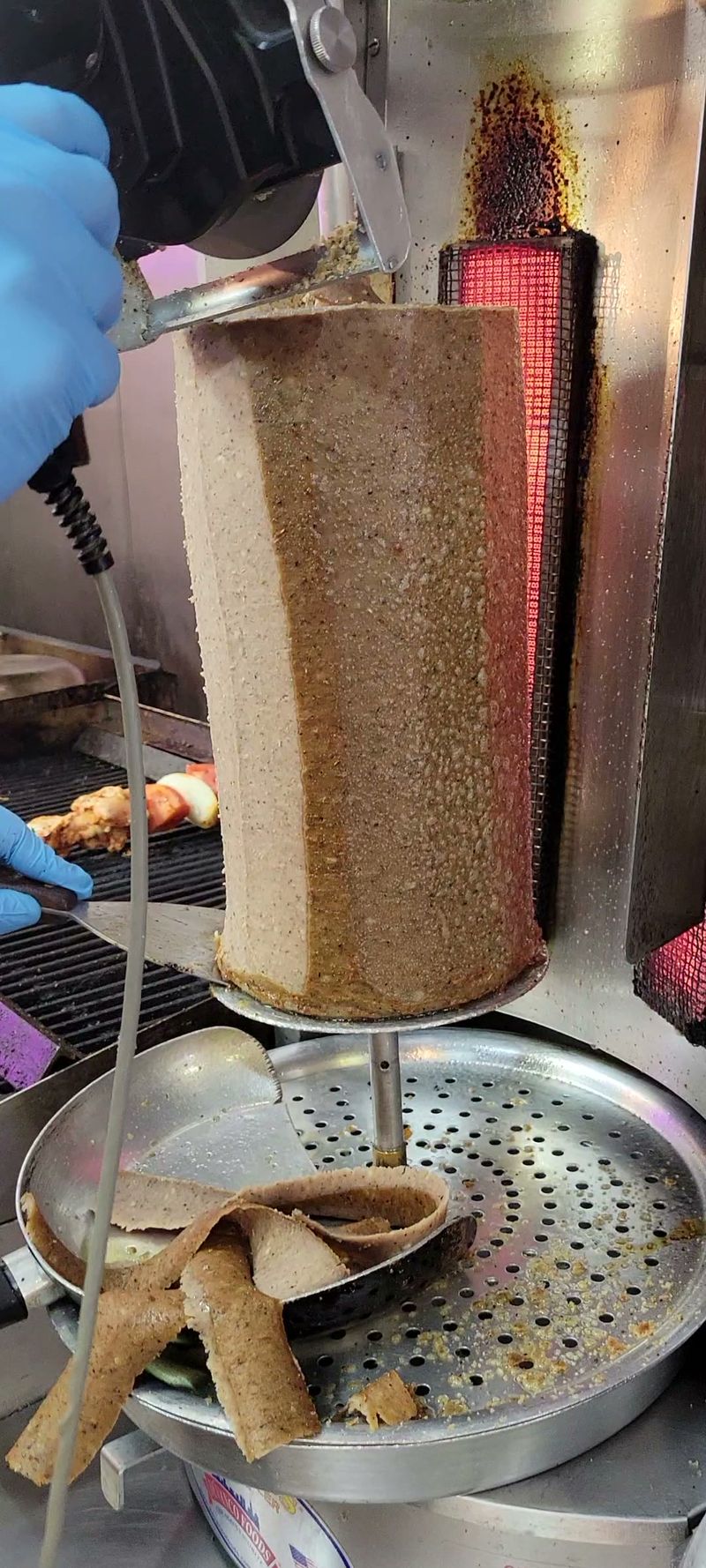 Shawarma being carved off the spit at FiL FiL